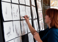 female designer sketches a nursing chair during a live workshop