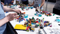 A group of people on an ideation session with legos